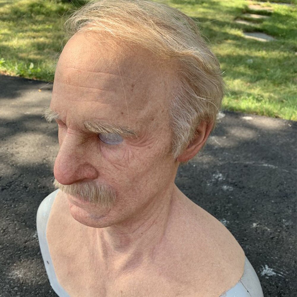 Realistic latex Halloween mask side view with gray hair and thin gray mustache