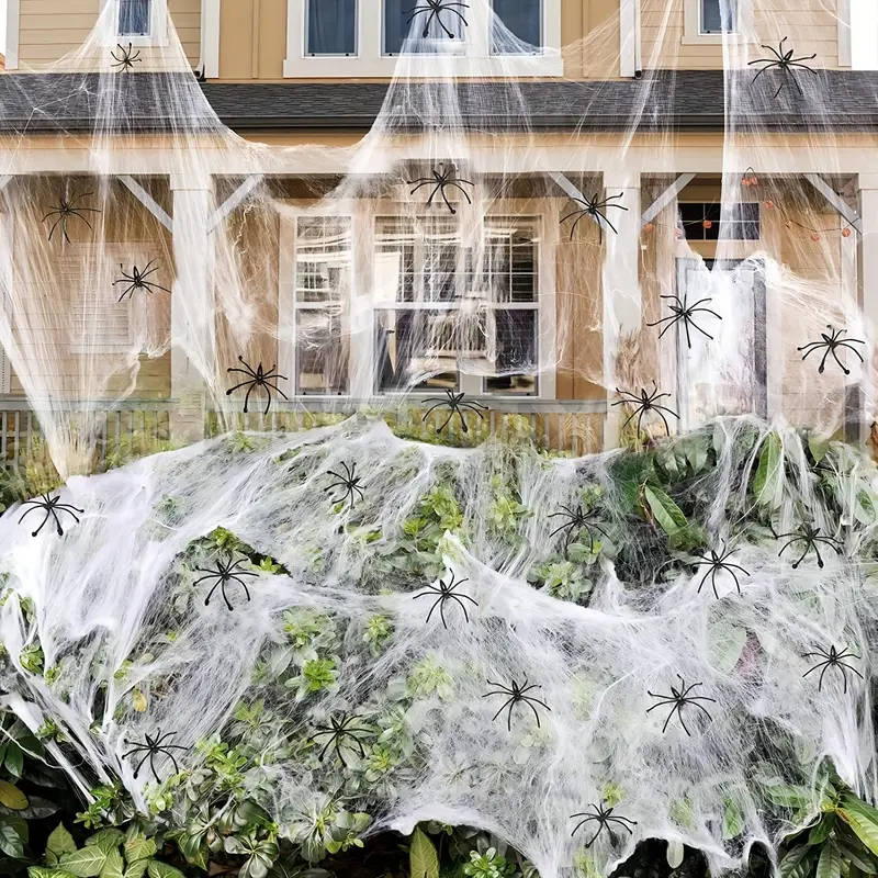 Stretchable spider web decoration covering a porch with white web and black spider figures