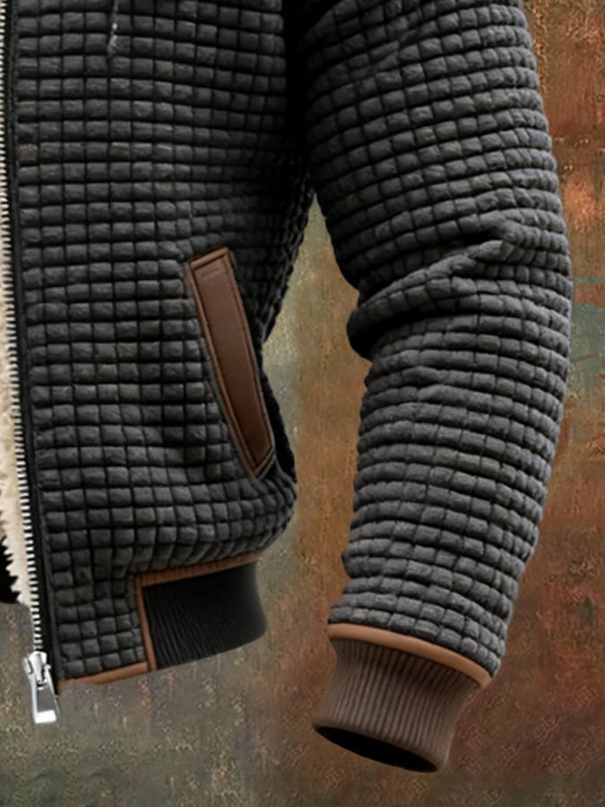 Men's black quilted sherpa-lined jacket detail, brown-trim side pocket and ribbed cuffs