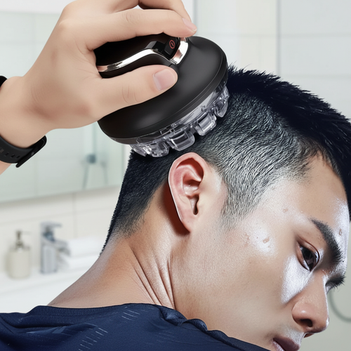 Cordless hair clipper trimming short hair; hand holds clipper against the head