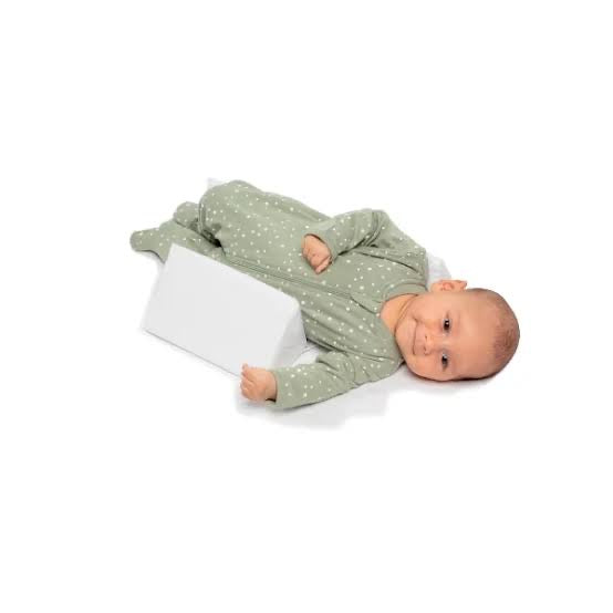 Adjustable baby side sleeper pillow with light green cover and white wedge cushions