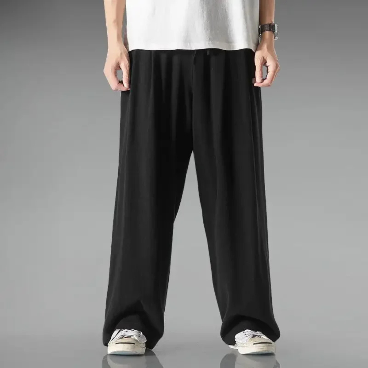Black relaxed-fit trousers with wide legs and elastic waistband with drawstring