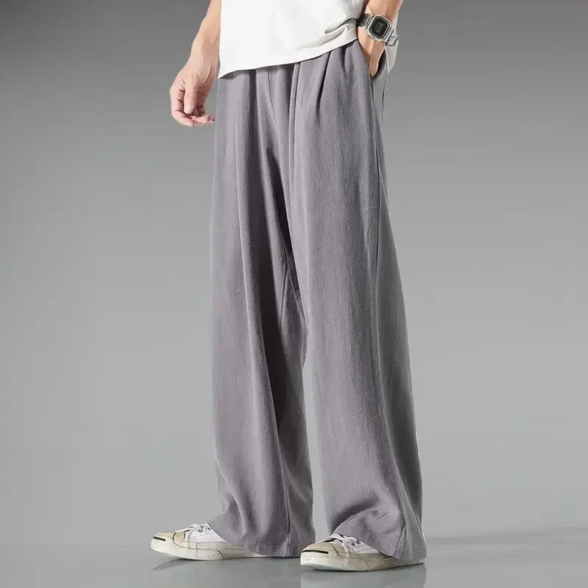 Grey relaxed-fit trousers with wide legs and elastic waistband, drawstring tie