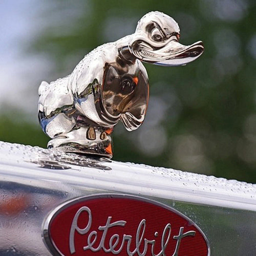Silver duck hood ornament with orange beak detail on rounded chrome base
