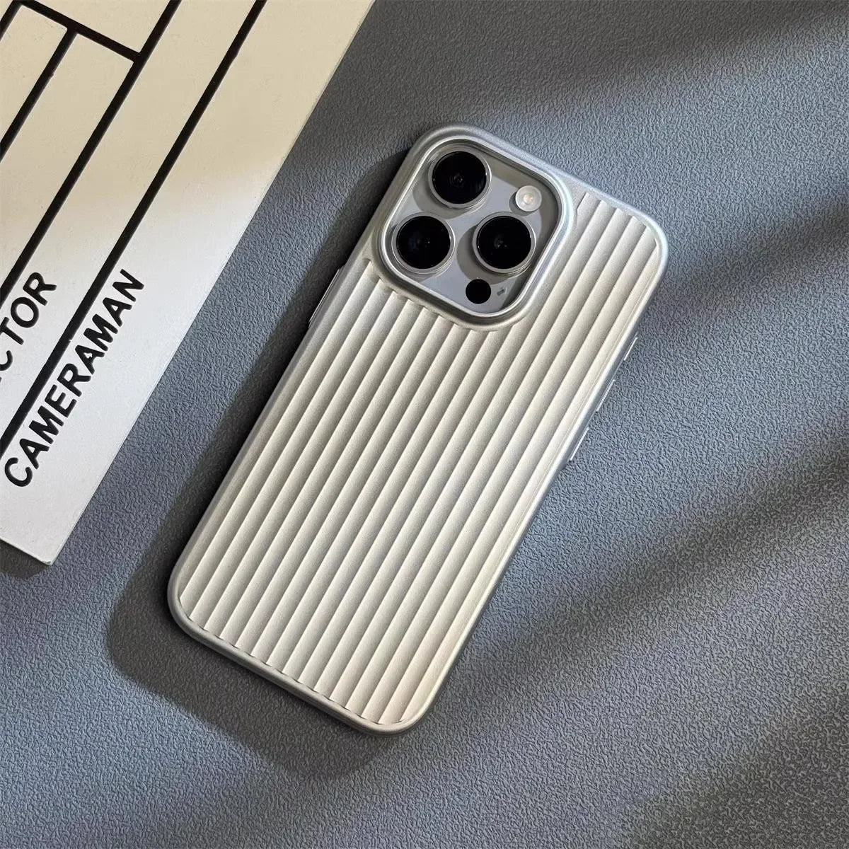 Light silver iPhone case with vertical ridged back and triple camera cutouts