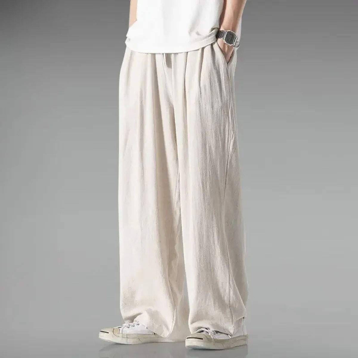 Cream relaxed-fit trousers with wide legs, elastic waistband, and drawstring