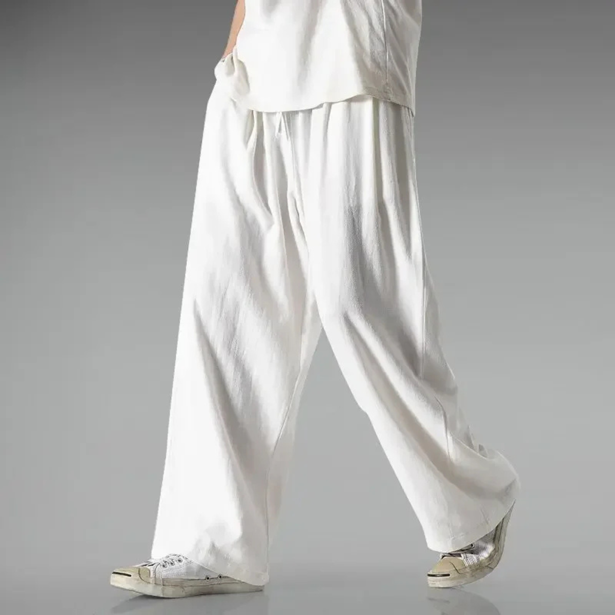 White relaxed-fit trousers with wide legs and elastic waistband with drawstring