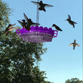 Purple ant-proof hummingbird feeder with clear base and hanging hook, side view