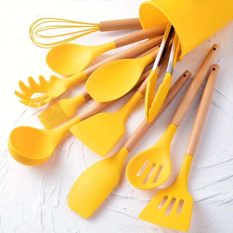 Yellow silicone kitchen utensil set with light wood handles: spatulas, ladle, whisk