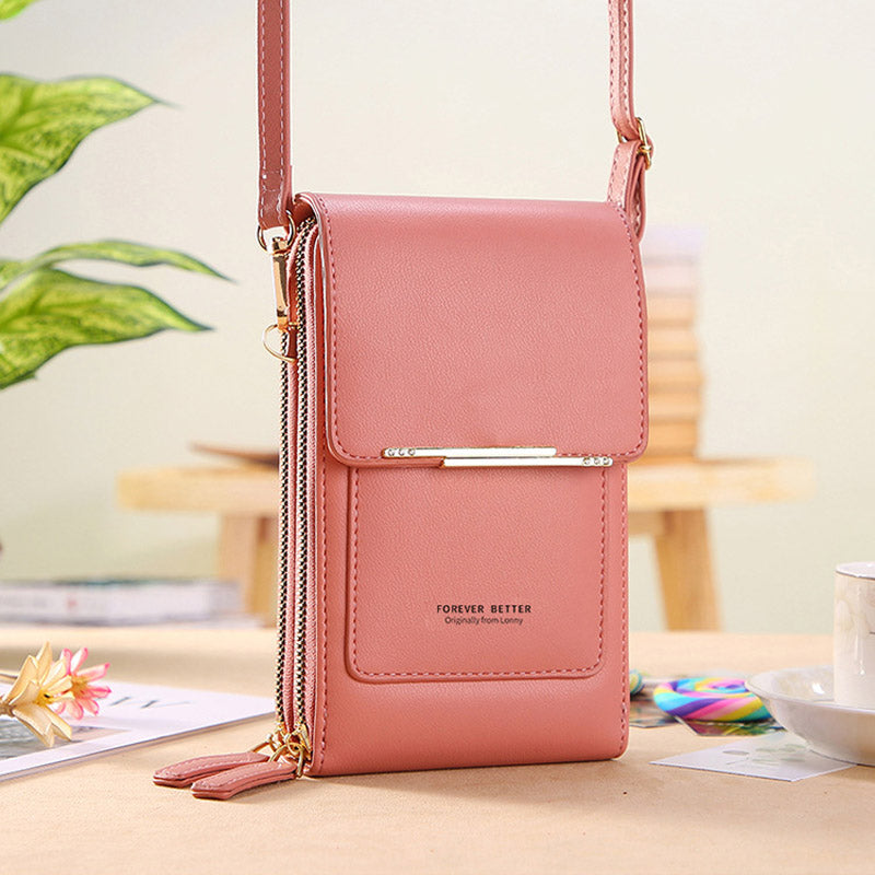 Anti-theft leather crossbody bag in pink, front flap with gold-tone bar closure.