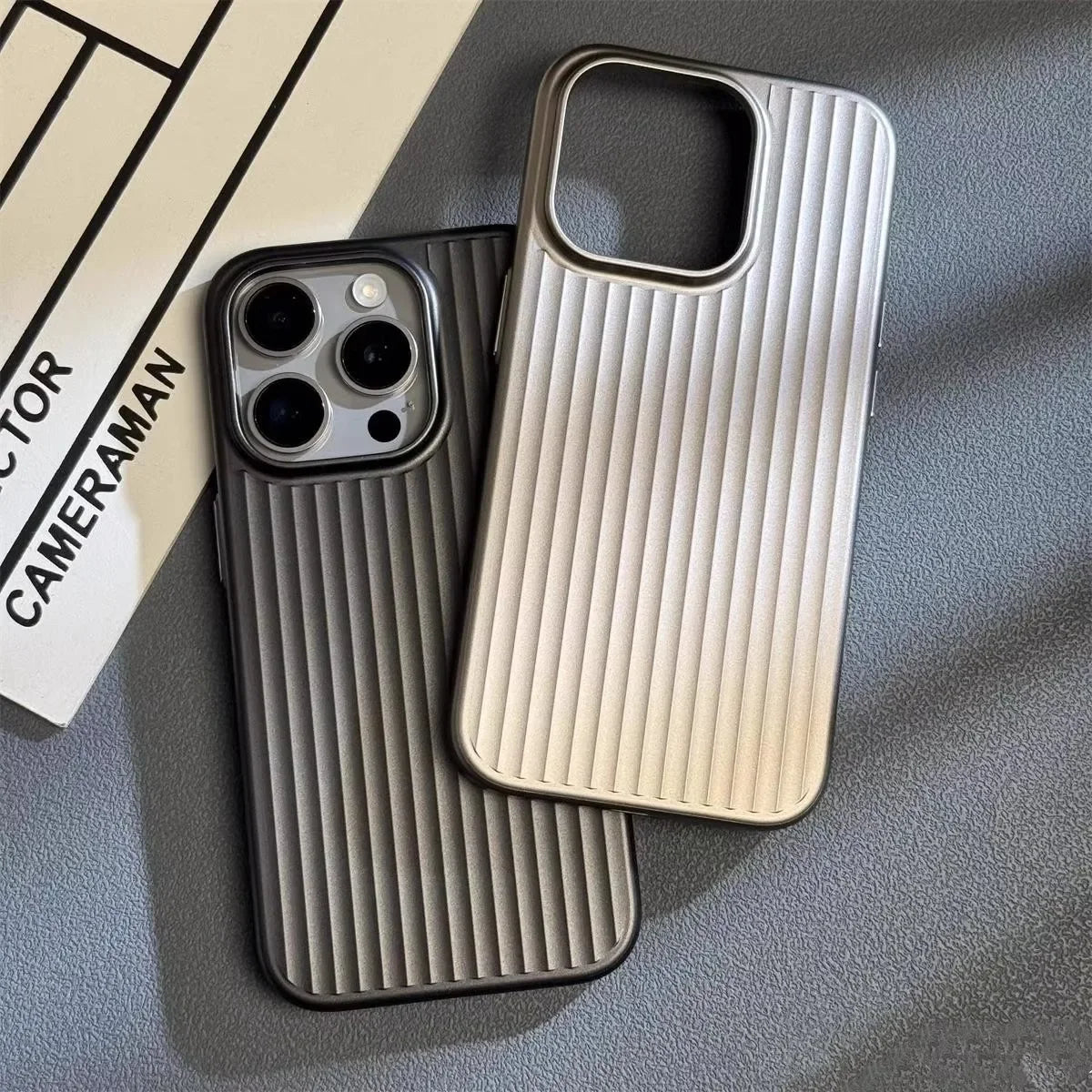 Two iPhone cases, black and cream, both with vertical ridged backs