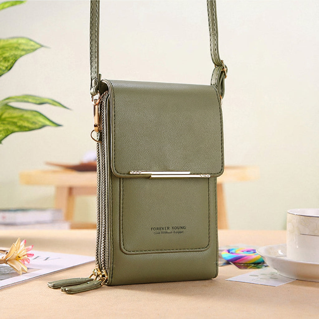 Anti-theft leather crossbody bag in green, front flap with gold-tone bar closure.