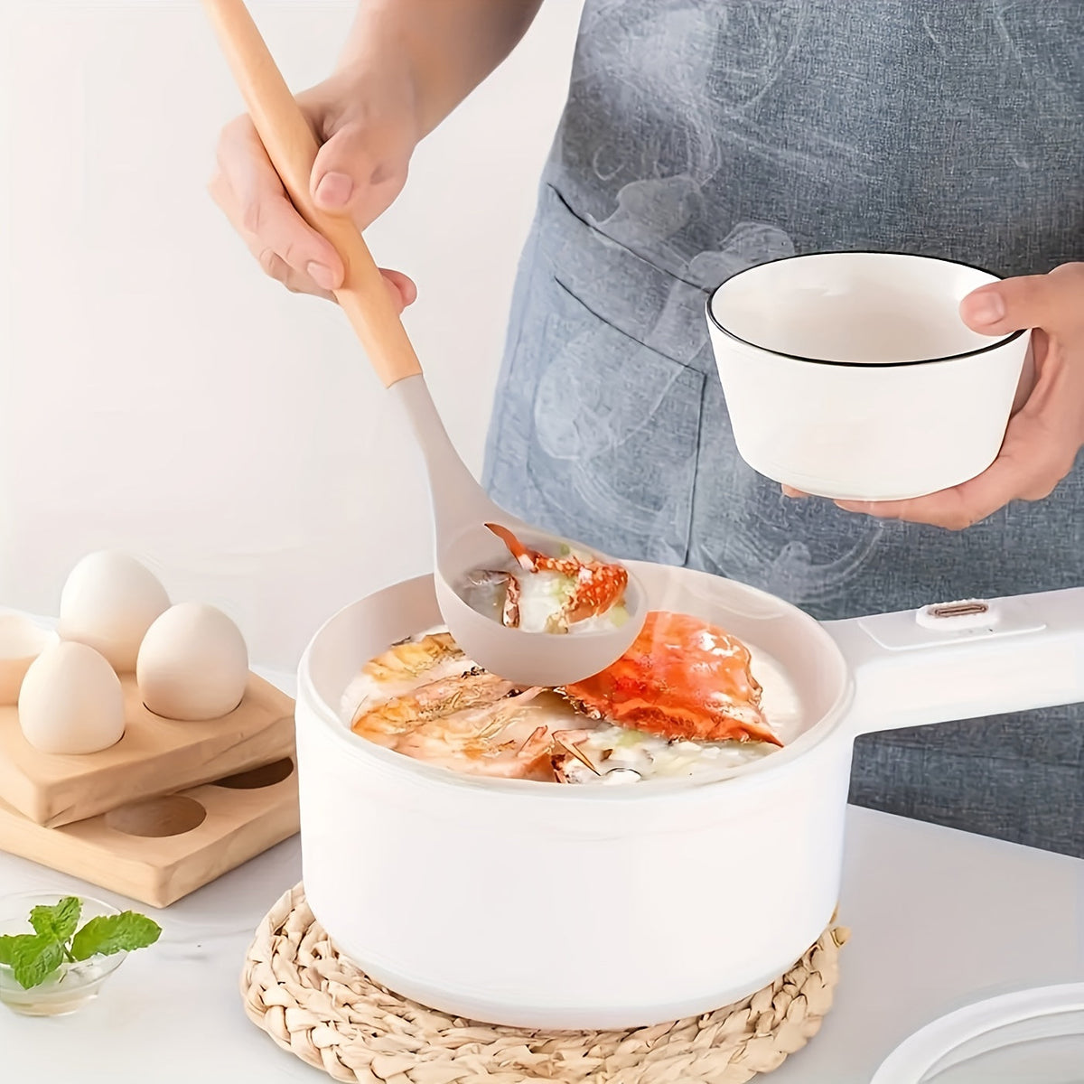 Silicone utensil with light wood handle and white head, used to serve food from a bowl.