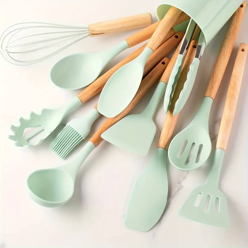 Mint green silicone kitchen utensil set with light wood handles: spatulas, ladle, whisk
