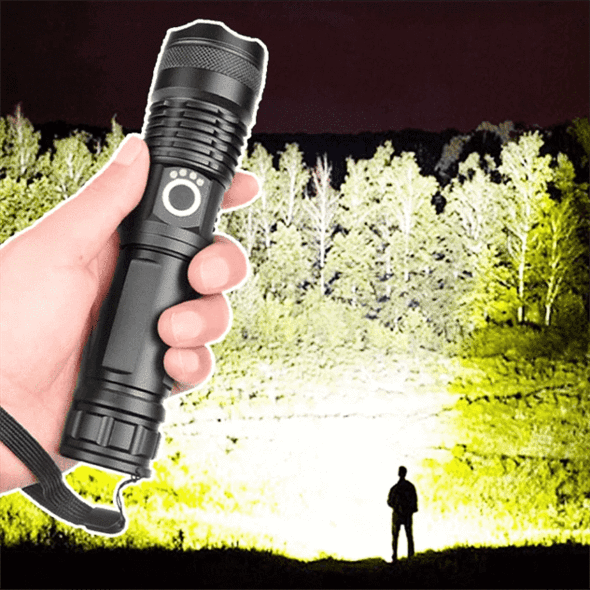 Hand holding a dark flashlight with a strong spotlight beam at night