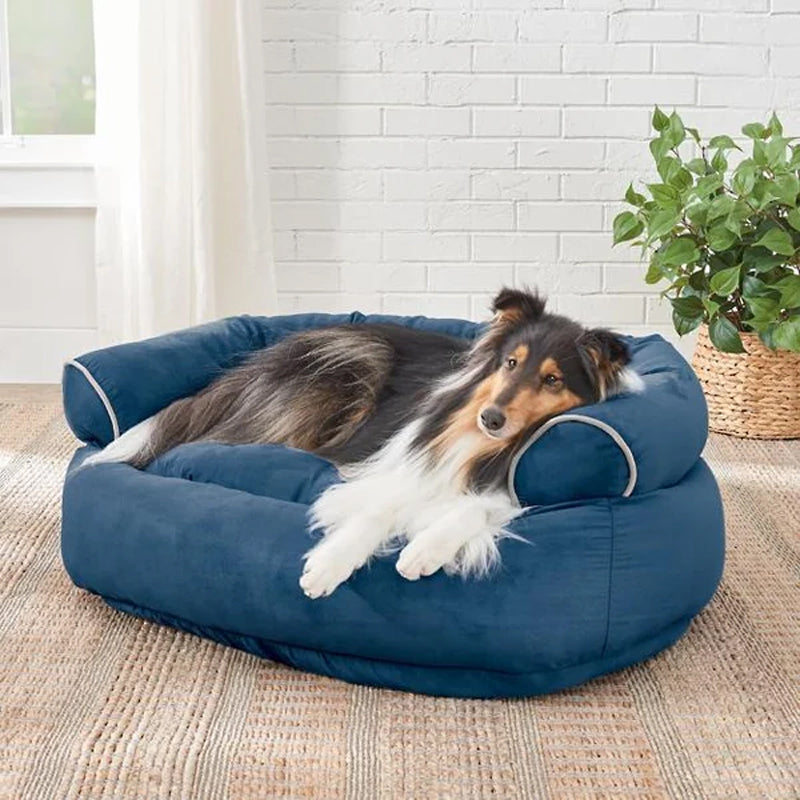 Bolster dog bed with rolled sides, blue fabric and beige piping detail