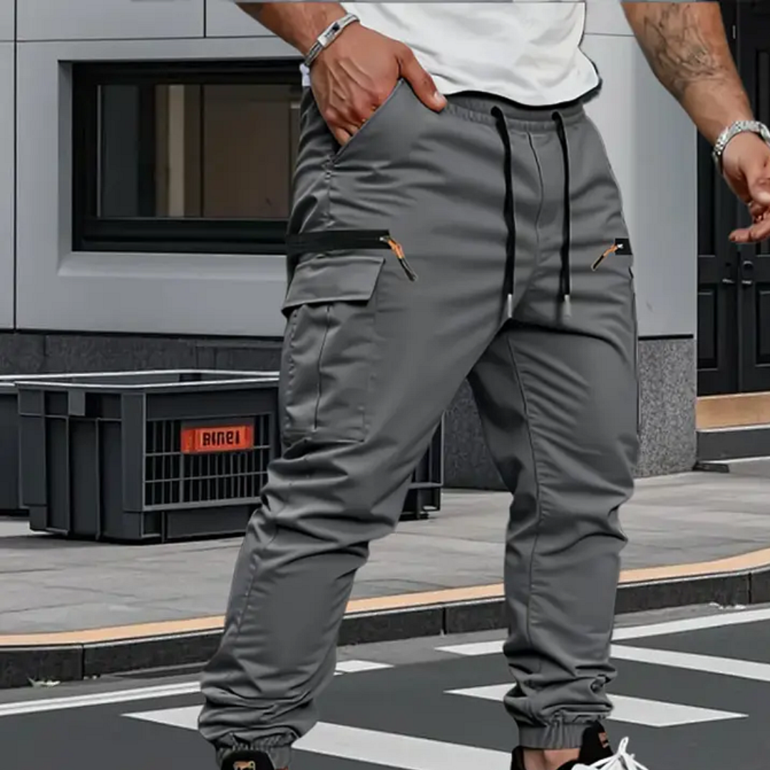 Gray tapered cargo pants with drawstring waist, cargo side pockets, elastic cuffs