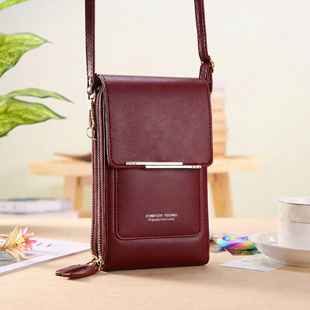 Anti-theft leather crossbody bag in wine red, with front flap and chain strap.