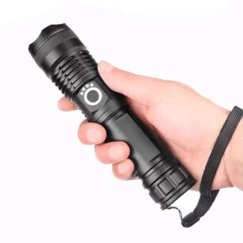 Close-up of a black rechargeable flashlight with textured grip and front switch