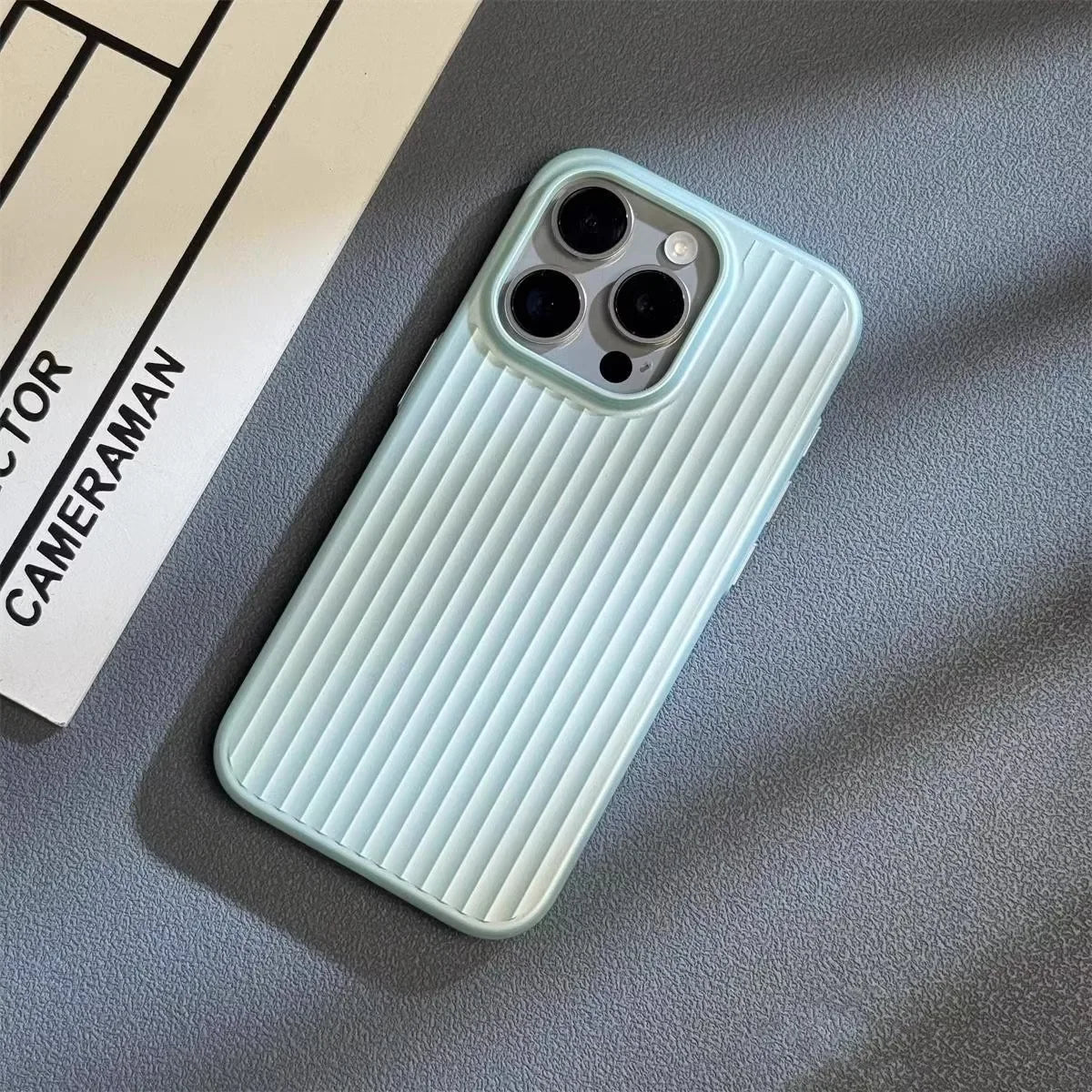 Light mint iPhone case with vertical ridged pattern and triple camera cutouts