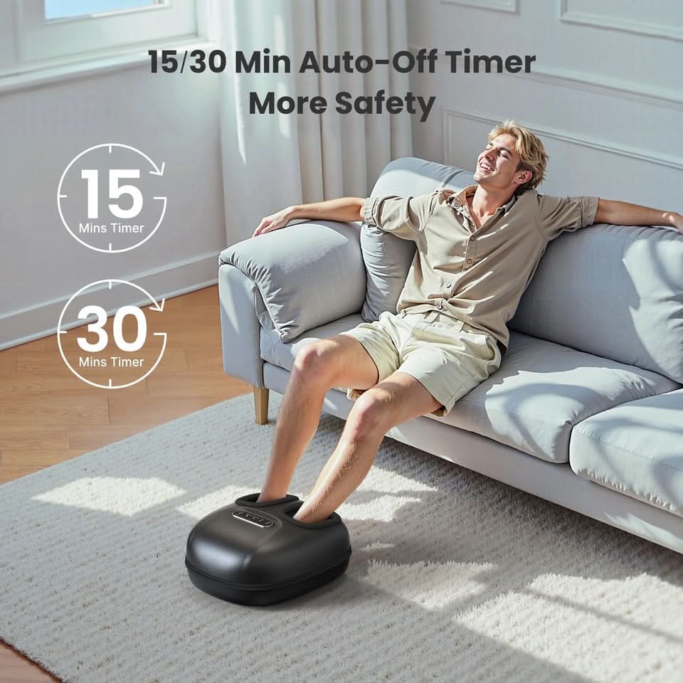 Black foot massager with timer auto-off, used under seated person's feet