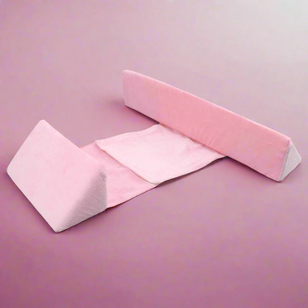 Adjustable baby side sleeper pillow with pink outer wedge and white inner pads