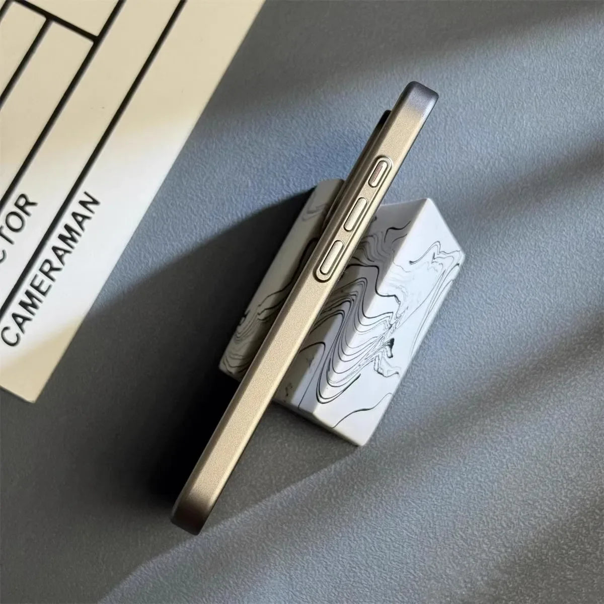 Silver iPhone case side view with buttons and camera cutout opening