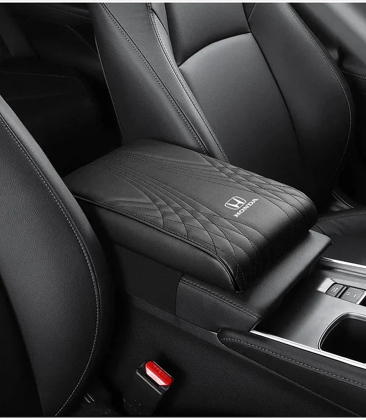 Black car armrest cushion cover with quilted stitching and small car-logo badge on top