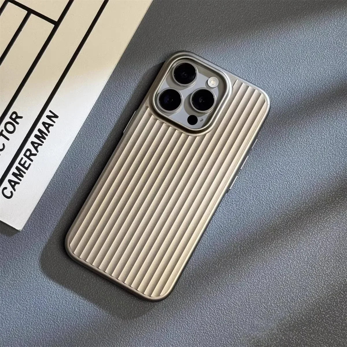 Cream iPhone case with vertical ridged back and triple camera cutouts