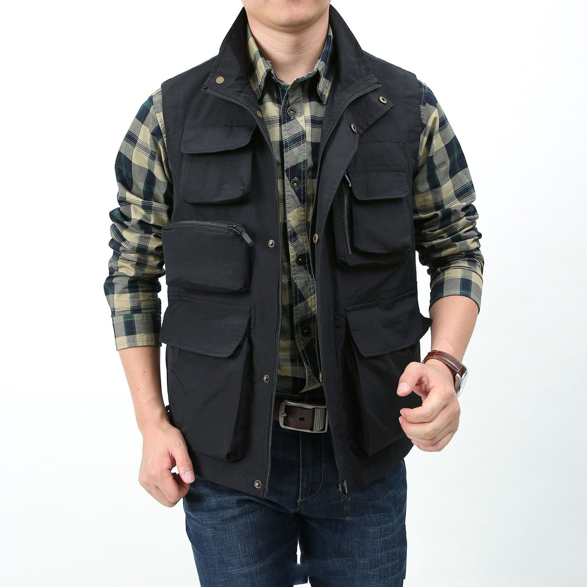 Black utility vest with multiple flap pockets, snap front, and utility-style drawstring hem