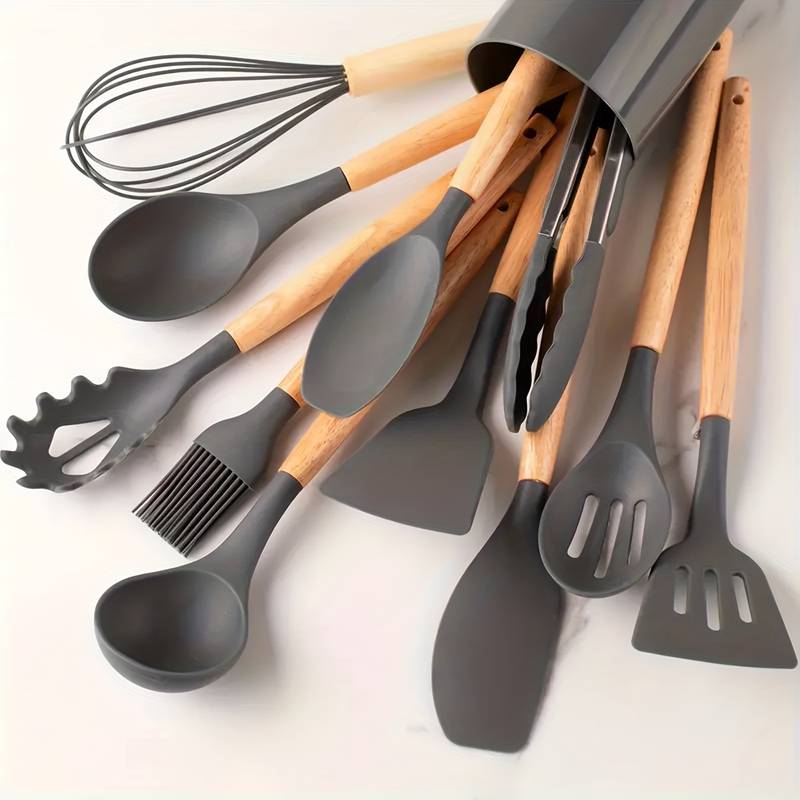 Dark gray silicone kitchen utensil set with light wood handles: ladle, spatulas, whisk