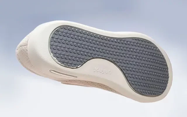 Beige diabetic shoe outsole with textured grip tread and side air vent window