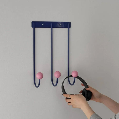 Color block metal wall hook set with blue rail, pink knobs, and three curved hooks