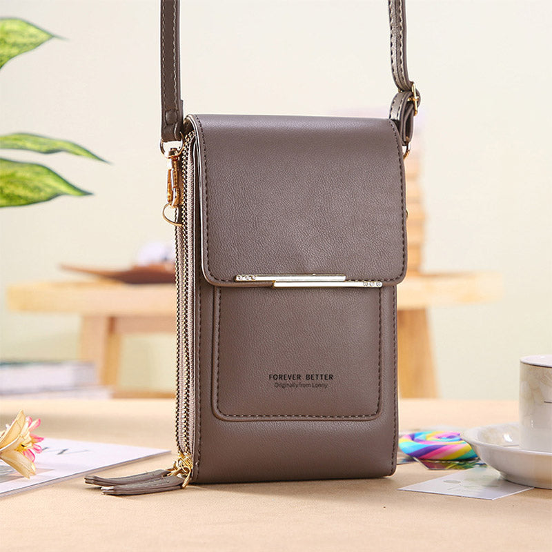 Dark leather crossbody bag with front flap and shoulder strap, zip pocket detail