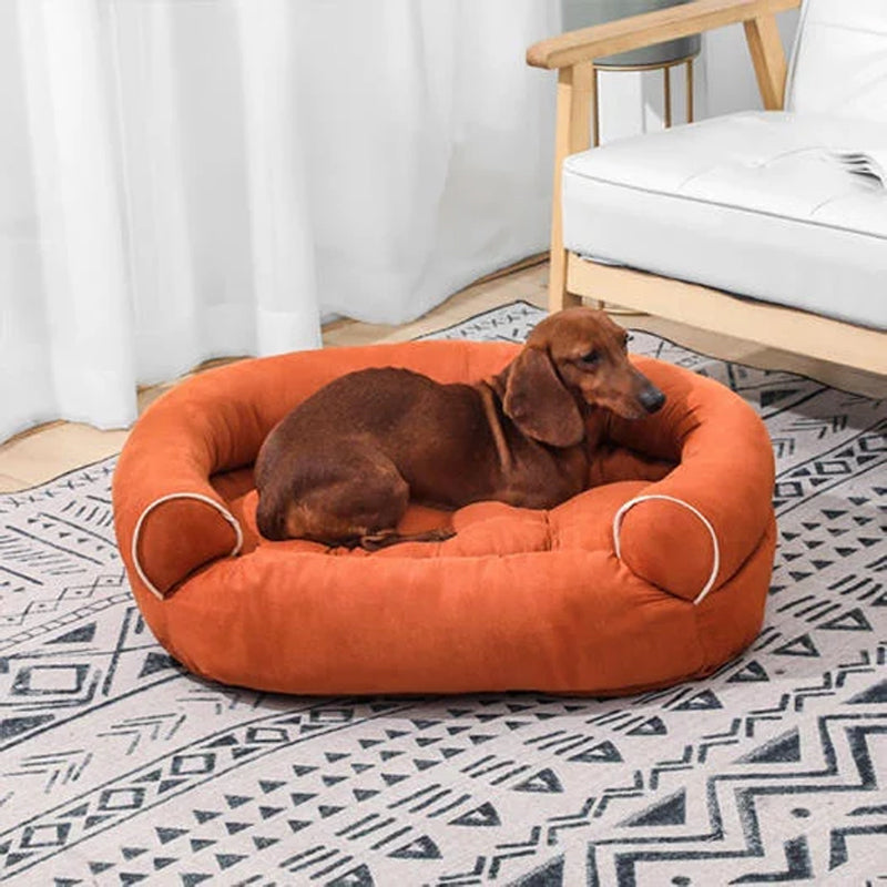 Bolster dog bed with rolled sides, orange fabric and beige piping