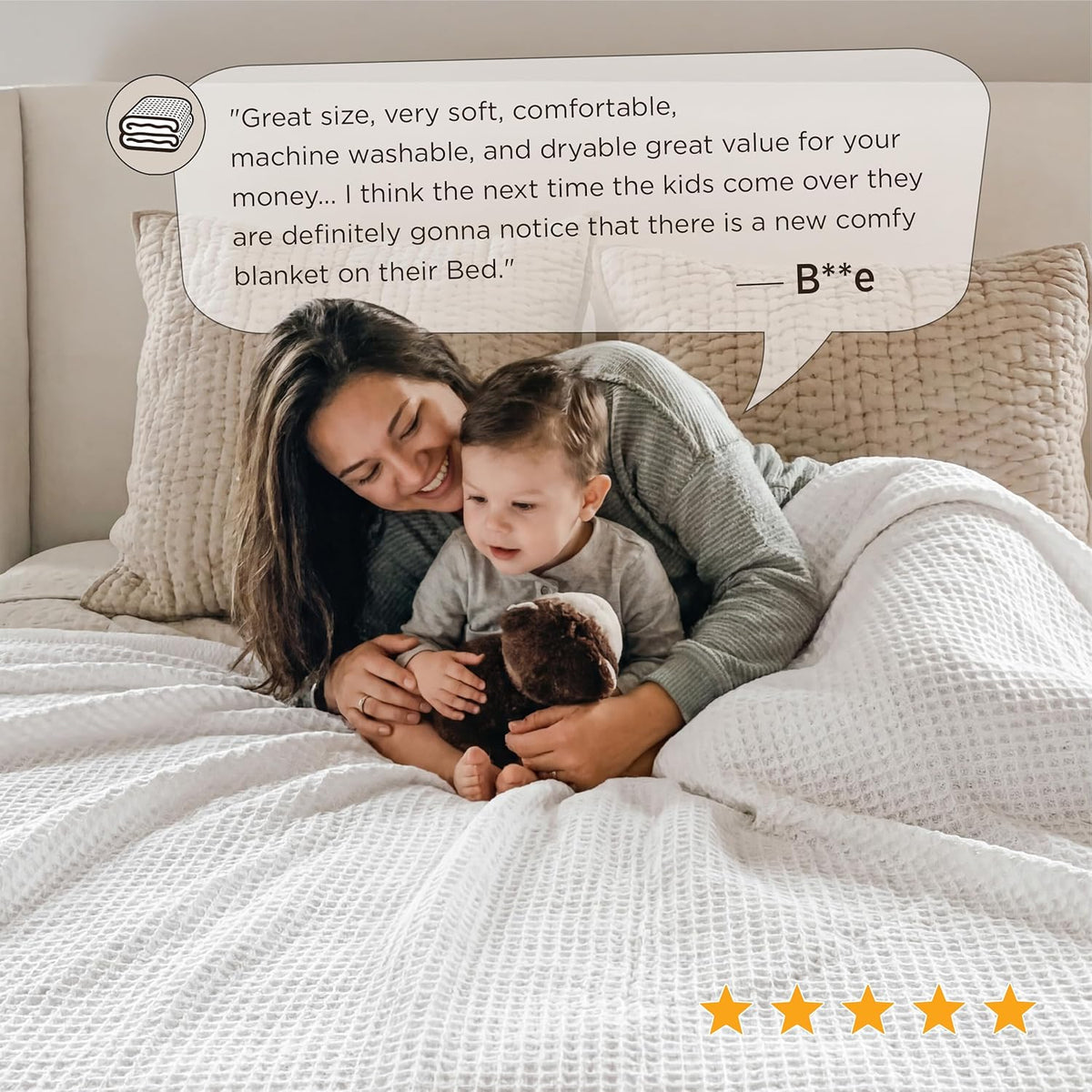 White cotton waffle-weave cooling blanket on a bed with a parent and child.