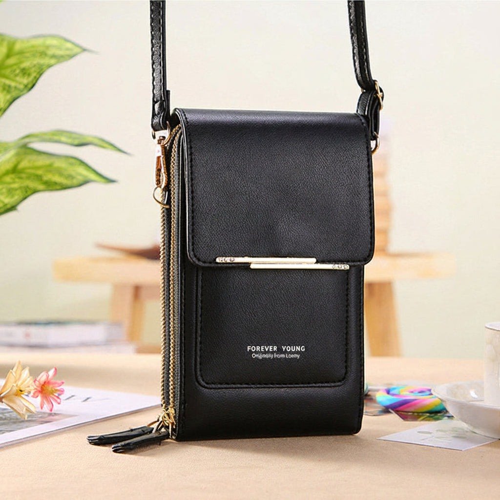 Anti-theft leather crossbody bag in black, front flap with gold-tone bar closure.