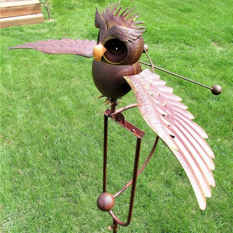 Wind-powered owl garden stake, brown metal body with open wings and round eyes