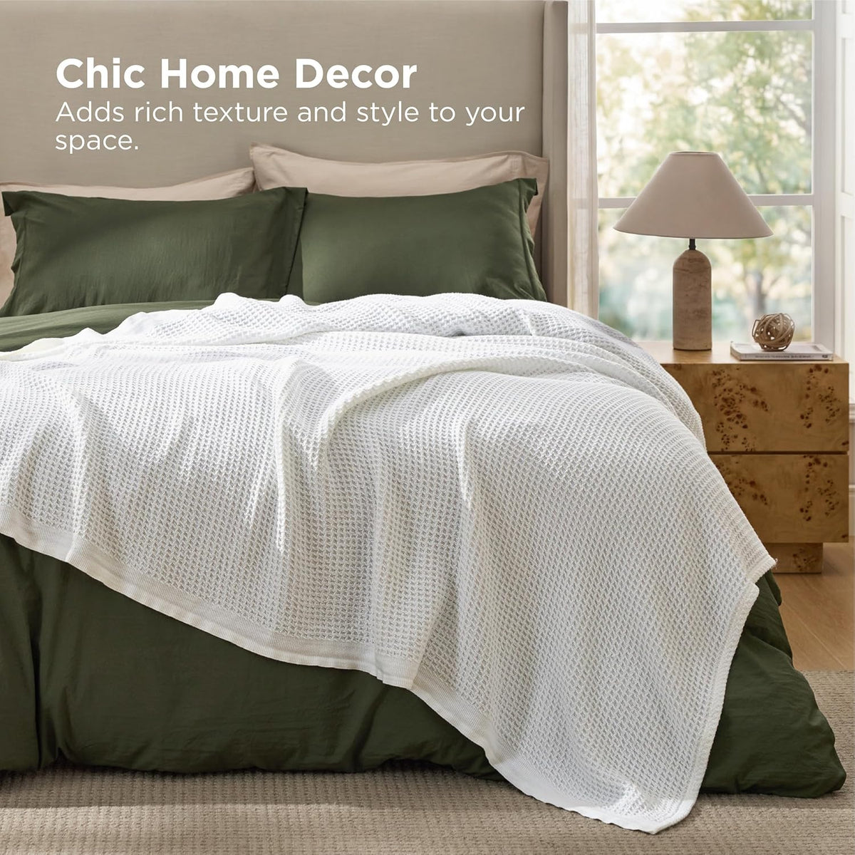 White cotton waffle-weave cooling blanket draped over a bed.