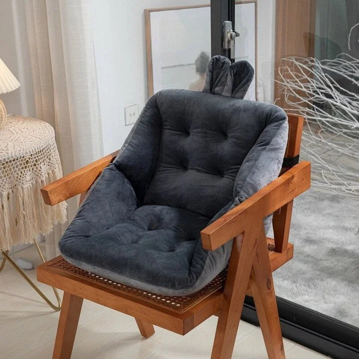 Sciatica relief cushion with dark gray padded backrest and contoured seat