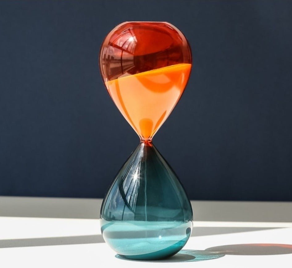 Hourglass sand timer with red-to-orange top and blue-green bottom glass