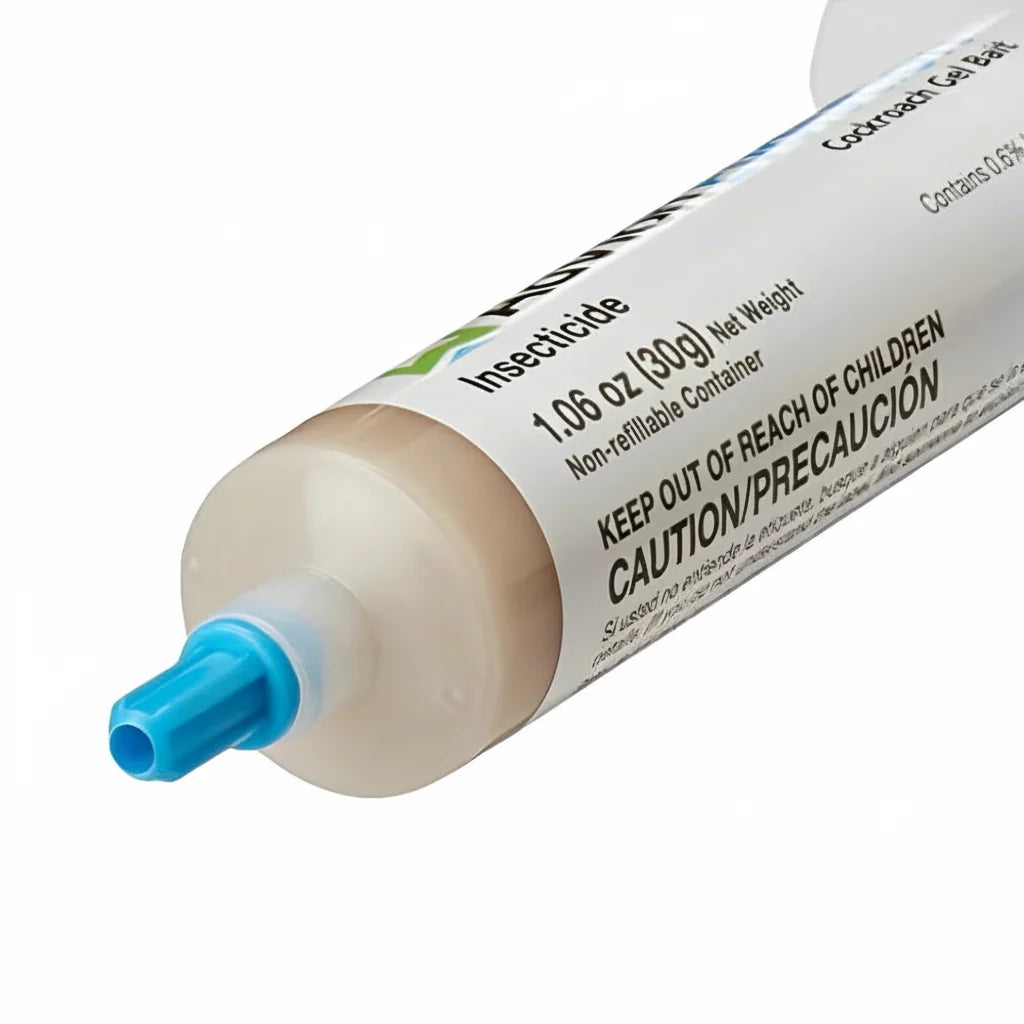 Roach gel bait tube close-up with blue nozzle and readable caution text.