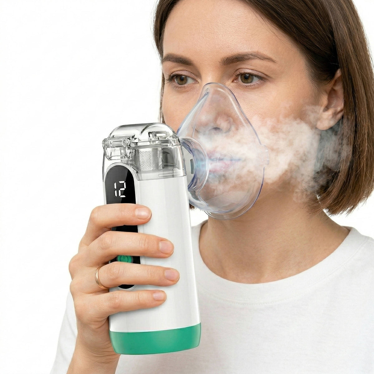 Compact white USB rechargeable mist inhaler with clear face mask and mist chamber