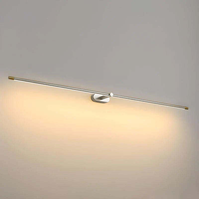 Silver-toned LED picture light bar with wall bracket, warm light illuminated