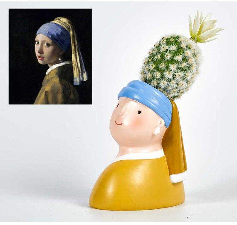 Ceramic face vase of girl with yellow dress, blue headband, and cactus hair