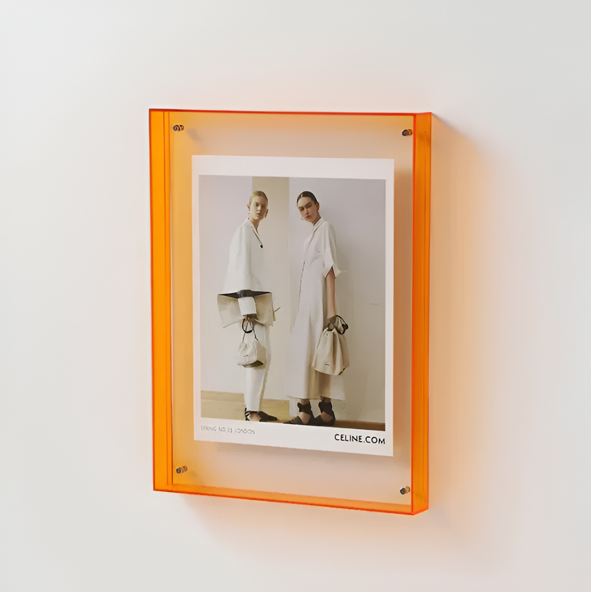 Orange floating photo frame with clear acrylic front and two-model photo print
