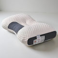 Neck contour sleeping pillow, white textured cover with dark gray support insert.