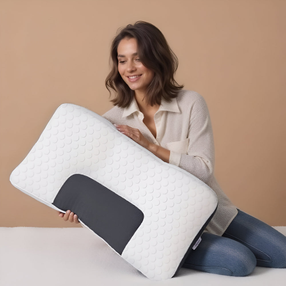 Neck contour sleeping pillow, white textured surface with dark gray neck support section.