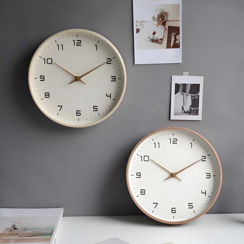 Wall clock set with cream faces, black numerals, and gold hands
