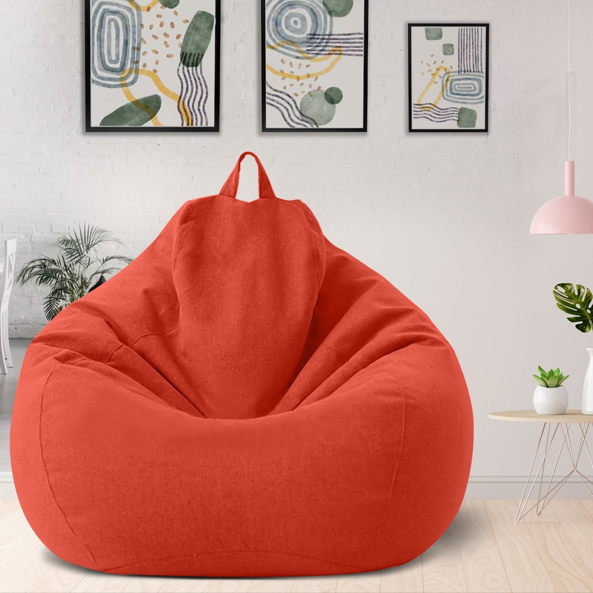 Red ergonomic bean bag cover with top handle and soft draped fabric